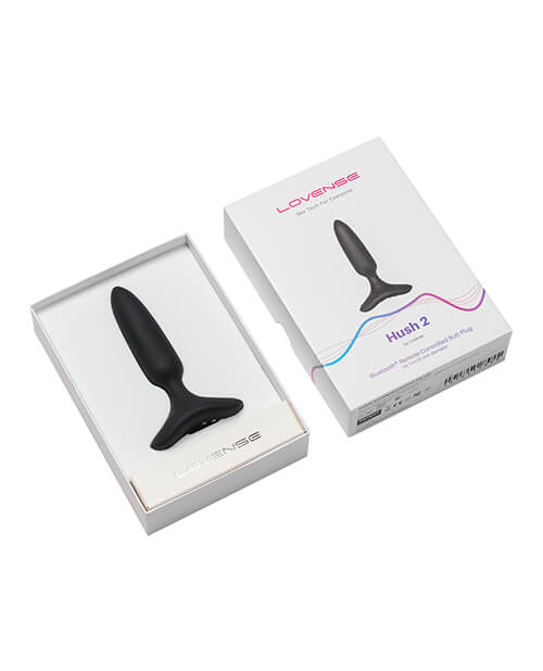 The Lovense Hush 2 resting inside of its packaging tray, shown next to the outer box | Kinkly Shop