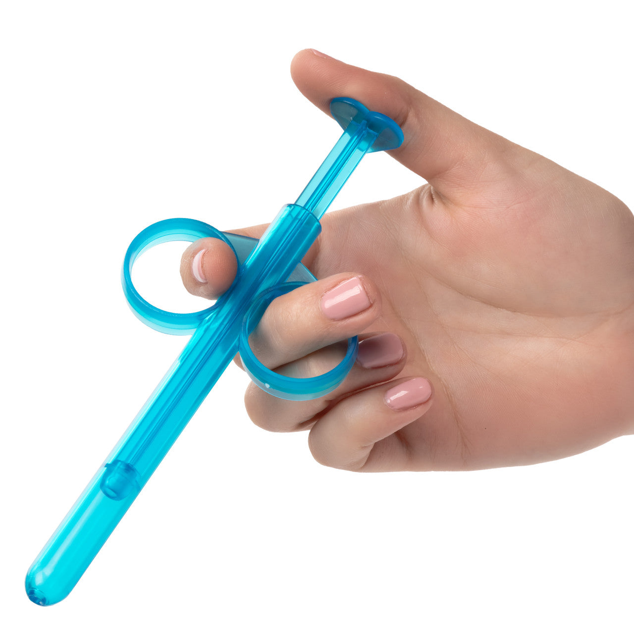 A hand holds the Lube Tube. Their pointer and middle finger are slid into the two open circle grips while their thumb depresses the lube shooter. | Kinkly Shop