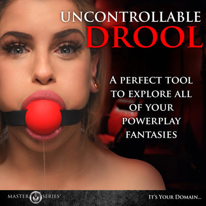 A person is wearing the Master Series Gag Order while they drool. Text on the image reads: Uncontrollable drool. A perfect tool to explore all of your powerplay fantasies. | Kinkly Shop