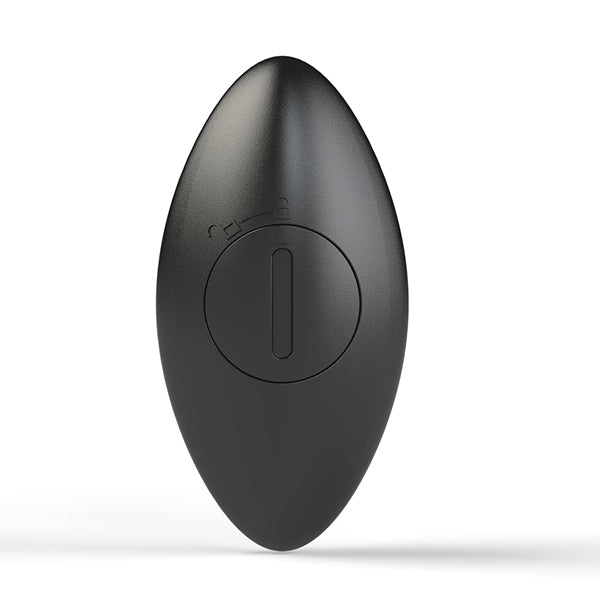 Close-up of the back-side of the Nexus Quattro Vibrating Anal Beads remote control. This showcases the remote's battery compartment which uses a coin-operated fastener to keep the battery secure inside the remote. | Kinkly Shop