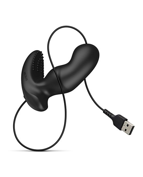 The Nexus Ride Extreme up against a white background. The charging cord is attached to the base of the prostate massager via the magnetic contact points. The charging cable, which ends in a male USB, is wrapped around the shaft of the toy for beautiful visuals. | Kinkly Shop