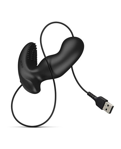 The Nexus Ride Extreme up against a white background. The charging cord is attached to the base of the prostate massager via the magnetic contact points. The charging cable, which ends in a male USB, is wrapped around the shaft of the toy for beautiful visuals. | Kinkly Shop