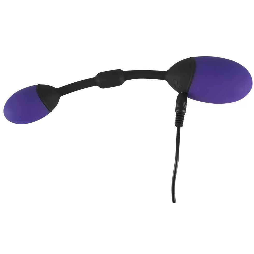 The GoGasm Vibrating Pussy & Ass Balls is plugged into its charger. The charging port is at the base of the vaginal ball. | Kinkly Shop