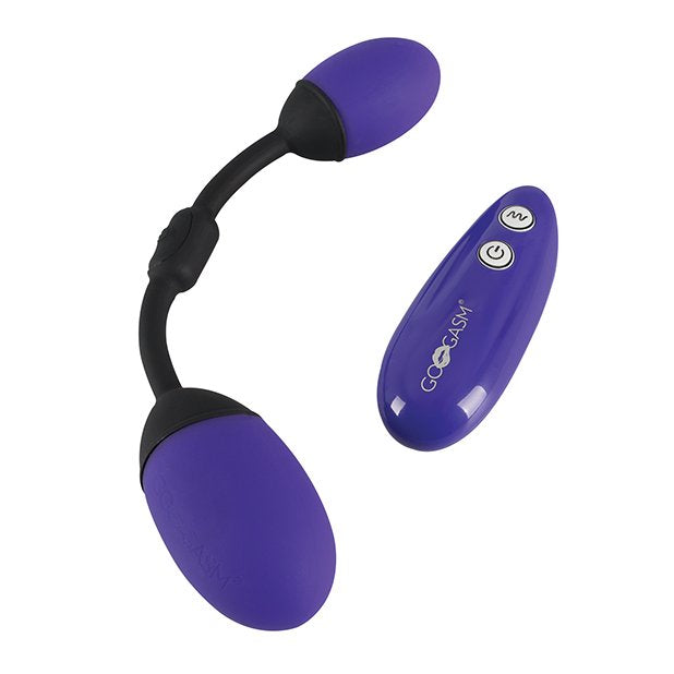 The GoGasm Vibrating Pussy & Ass Balls sitting out next to their remote control | Kinkly Shop