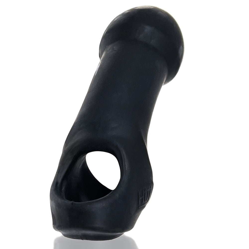 Close up of the holes at the base of the Oxballs Double Thruster. The viewer can see "through" the three holes in the base, showcasing the dedicated testicle strap and erection strap. | Kinkly Shop