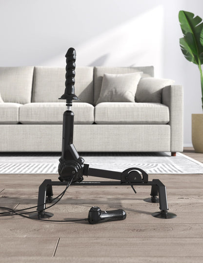 The Body Dock Pro Suction-Cup Machine in front of the couch. The dildo is positioned towards the ceiling, showcasing positioning potential of the machine. | Kinkly Shop