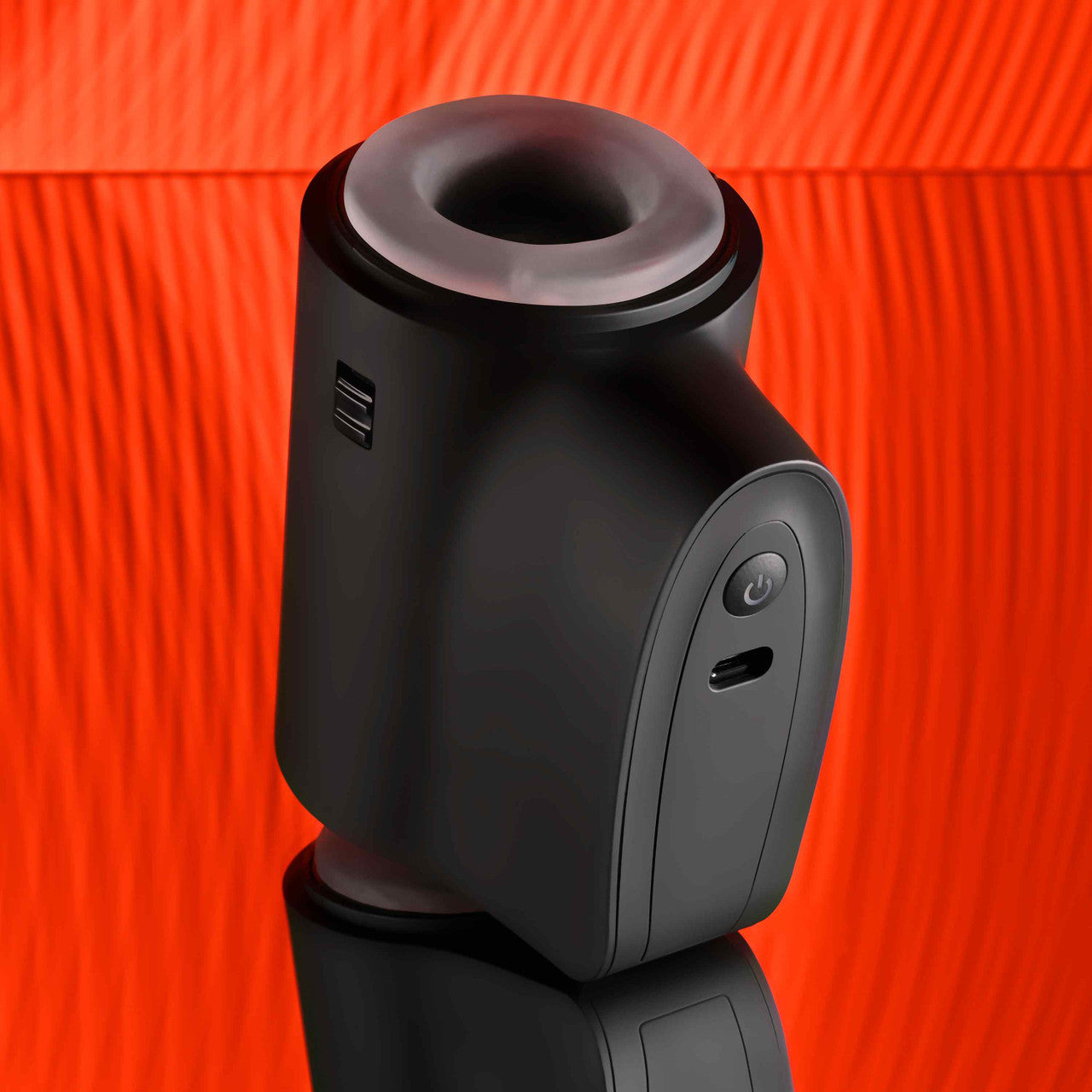 The Playboy Come Along with the powered unit showing towards the camera. There's a charging port for the toy right underneath the toy's power button on this large, protruding side. | Kinkly Shop
