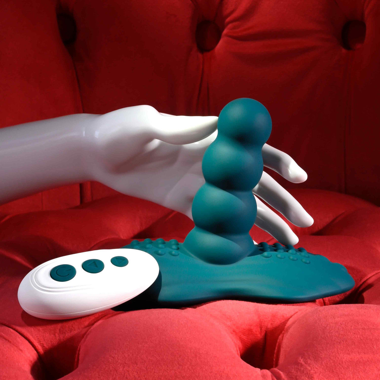 The Playboy Have A Seat shown with a hand wrapped around the insertable shaft. The shaft looks relatively thick compared to the hand. | Kinkly