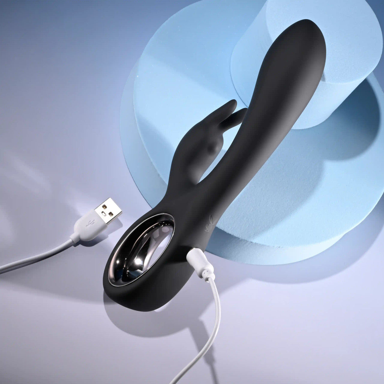 The Playboy Late Night Bunny plugged into its charger. The opposite end of the charger has a male USB plug. | Kinkly Shop