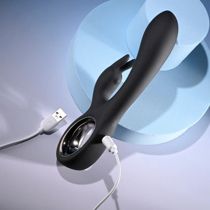 The Playboy Late Night Bunny plugged into its charger. The opposite end of the charger has a male USB plug. | Kinkly Shop
