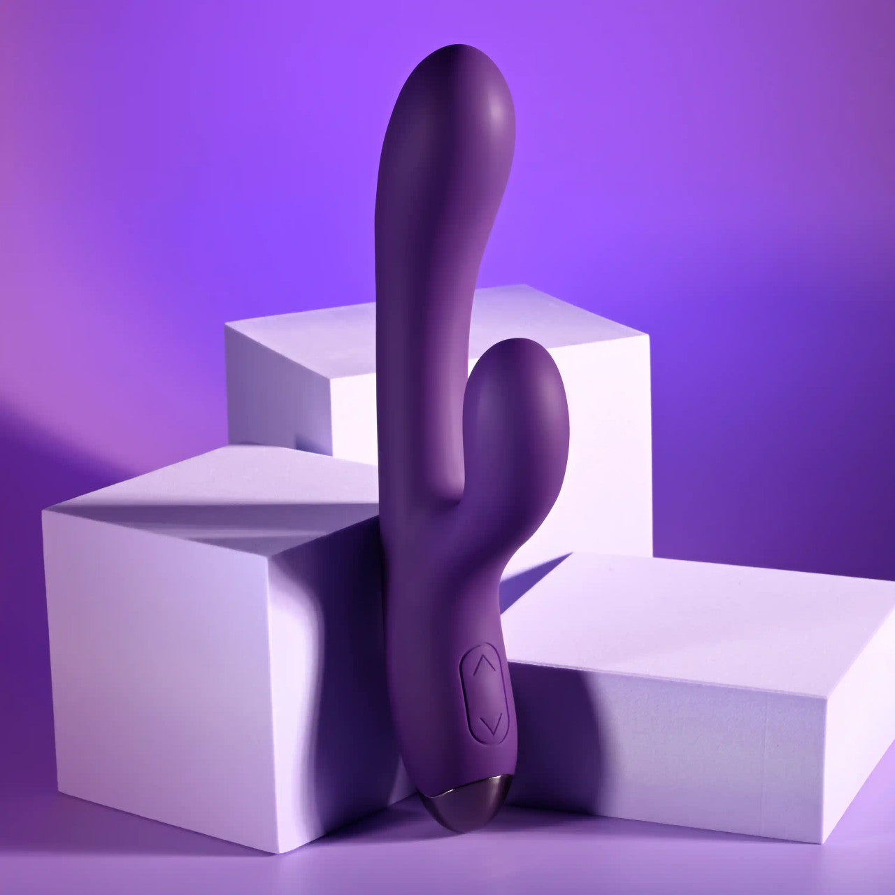 The Playboy New Crush resting up against a stack of boxes. It has an up and down button on the base to control the vibrations. | Kinkly Shop