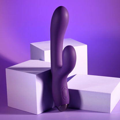 The Playboy New Crush resting up against a stack of boxes. It has an up and down button on the base to control the vibrations. | Kinkly Shop