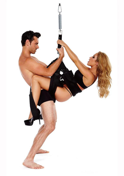 A couple uses the WhipSmart Pleasure Swing. The sex swing straps look very wide and comfortable and there's an additional strap to help support the feet. | Kinkly Shop
