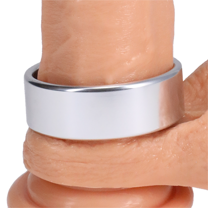 The Rock Solid Brushed Alloy in XL wrapped around the base of a dildo | Kinkly Shop