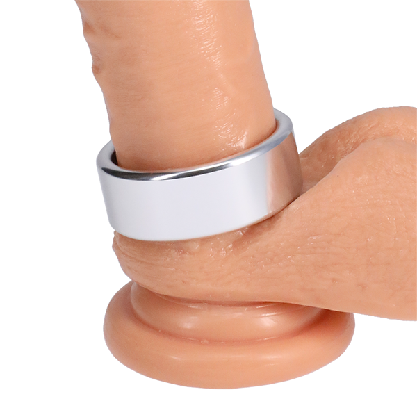 The Rock Solid Brushed Alloy in Large wrapped around the base of a dildo | Kinkly Shop