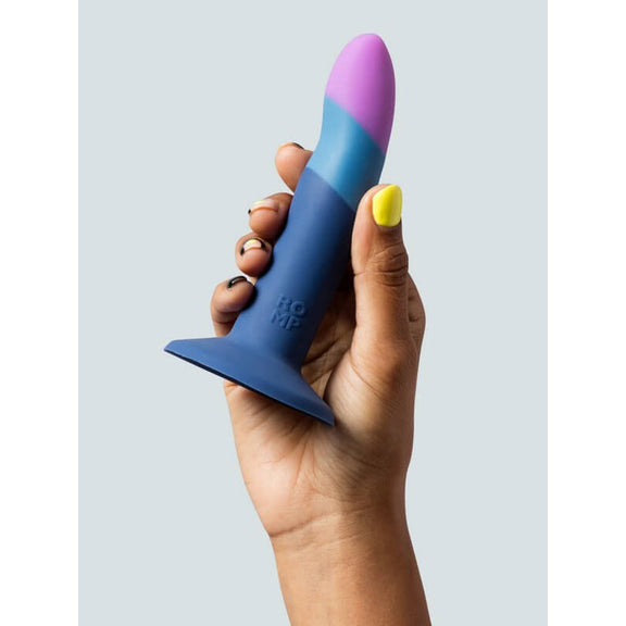 A hand holds the ROMP Piccolo. The dildo looks about the length of the person's flattened hand from base of palm to tip of finger, and only about as thick as 2.5 fingers. | Kinkly Shop