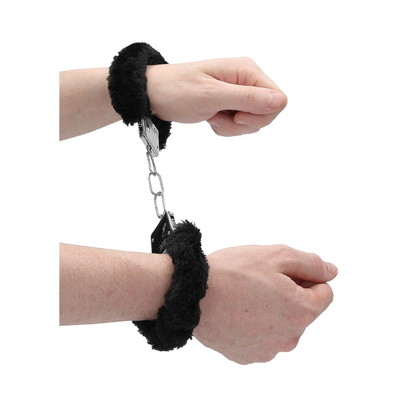 Two hands bound in the Ouch! Furry Handcuffs. There's 3 links of chain in-between the two cuffs. | Kinkly Shop