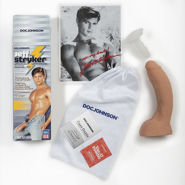 Everything that comes with the Signature Cocks Jeff Stryker dildo. There's the drawstring bag, the care guide, a sample of dildo care powder, a photo of Jeff, and the dildo itself. | Kinkly Shop
