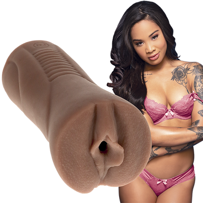 Honey Gold, in lingerie, stares seductively at the camera while the Signature Strokers - Honey Gold, molded after her parts, is shown right next to her. | Kinkly