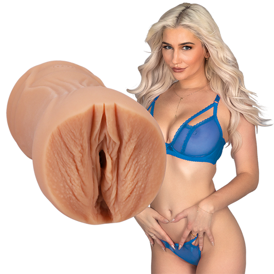 Skye is standing next to the Signature Strokers - Skye Blue, looking into the camera. The entrance of the stroker is directly molded from Skye's own vulva. | Kinkly Shop