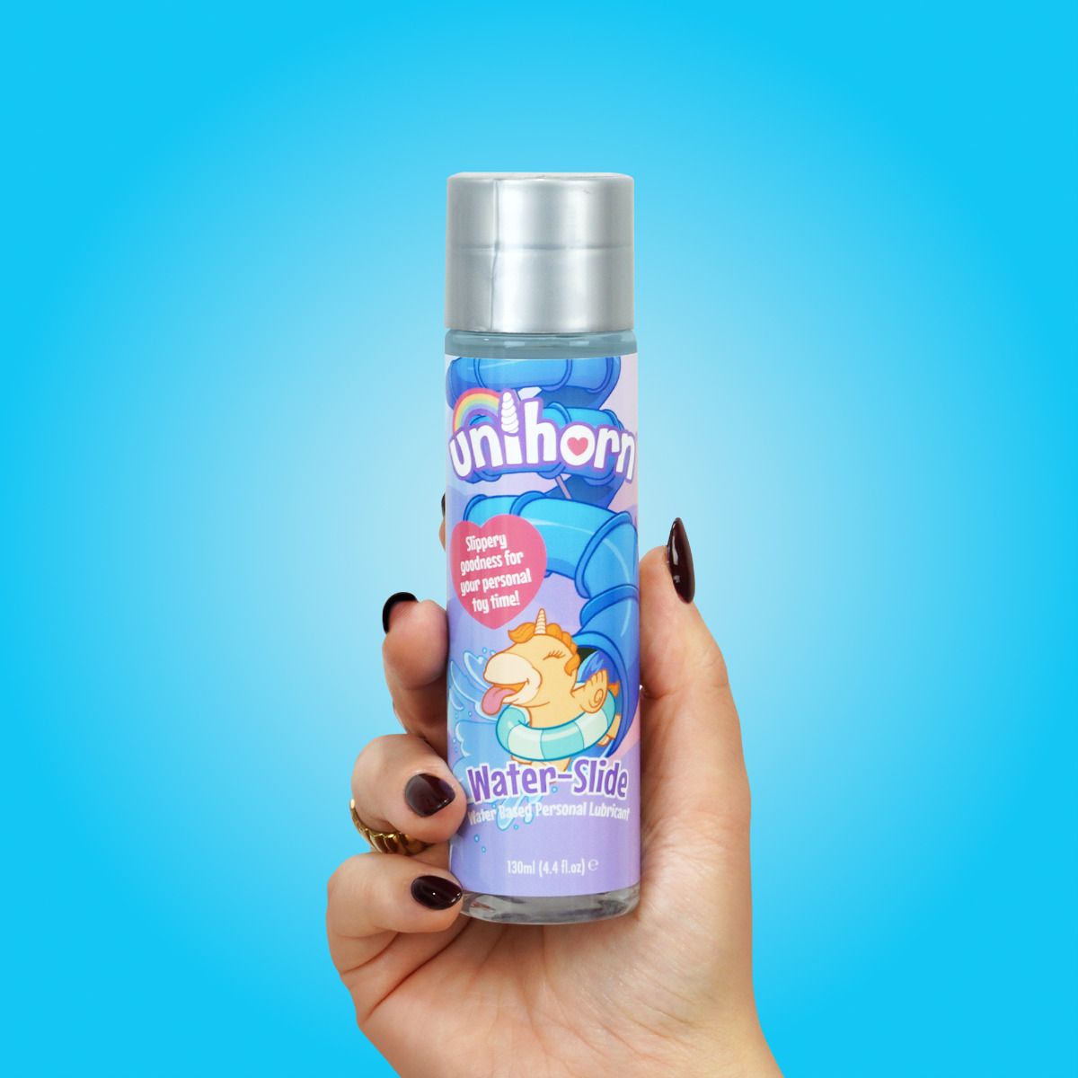 A person holds the Unihorn Lube - 4.4 oz. The bottle looks comfortable and easy to grip. | Kinkly Shop