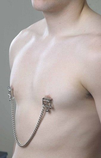 A person with smaller nipples wears the Spartacus Press Nipple Clamps. They look secure as they drape off the nipples. | Kinkly Shop