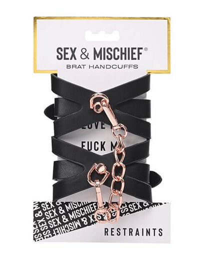 Sportsheets Brat Cuffs in its packaging. The two cuffs come wrapped around a single piece of cardboard. It does not look like they come inside of an enclosed box. | Kinkly Shop