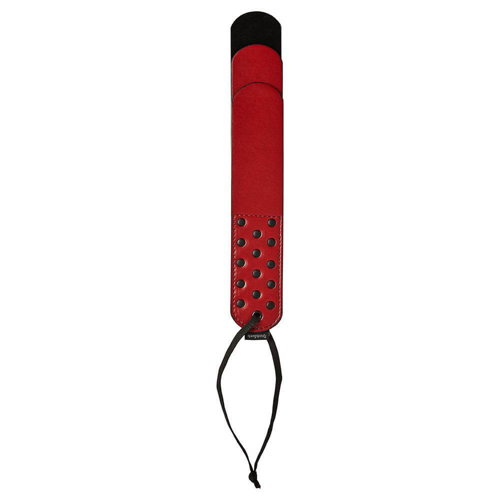 Top-down view of the Sportsheets Saffron Layer Paddle. The "handle" is covered in rivets for easier gripping. | Kinkly Shop