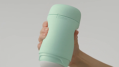 A hand squeezes the Tenga Puffy, showcasing how the pillowy, soft design of the stroker works. | Kinkly Shop