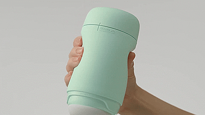 A hand squeezes the Tenga Puffy, showcasing how the pillowy, soft design of the stroker works. | Kinkly Shop