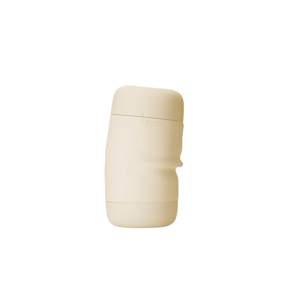 The Tenga Puffy in latte brown shown sliding sideways, showcasing the softness and bendability of the stroker. | Kinkly Shop