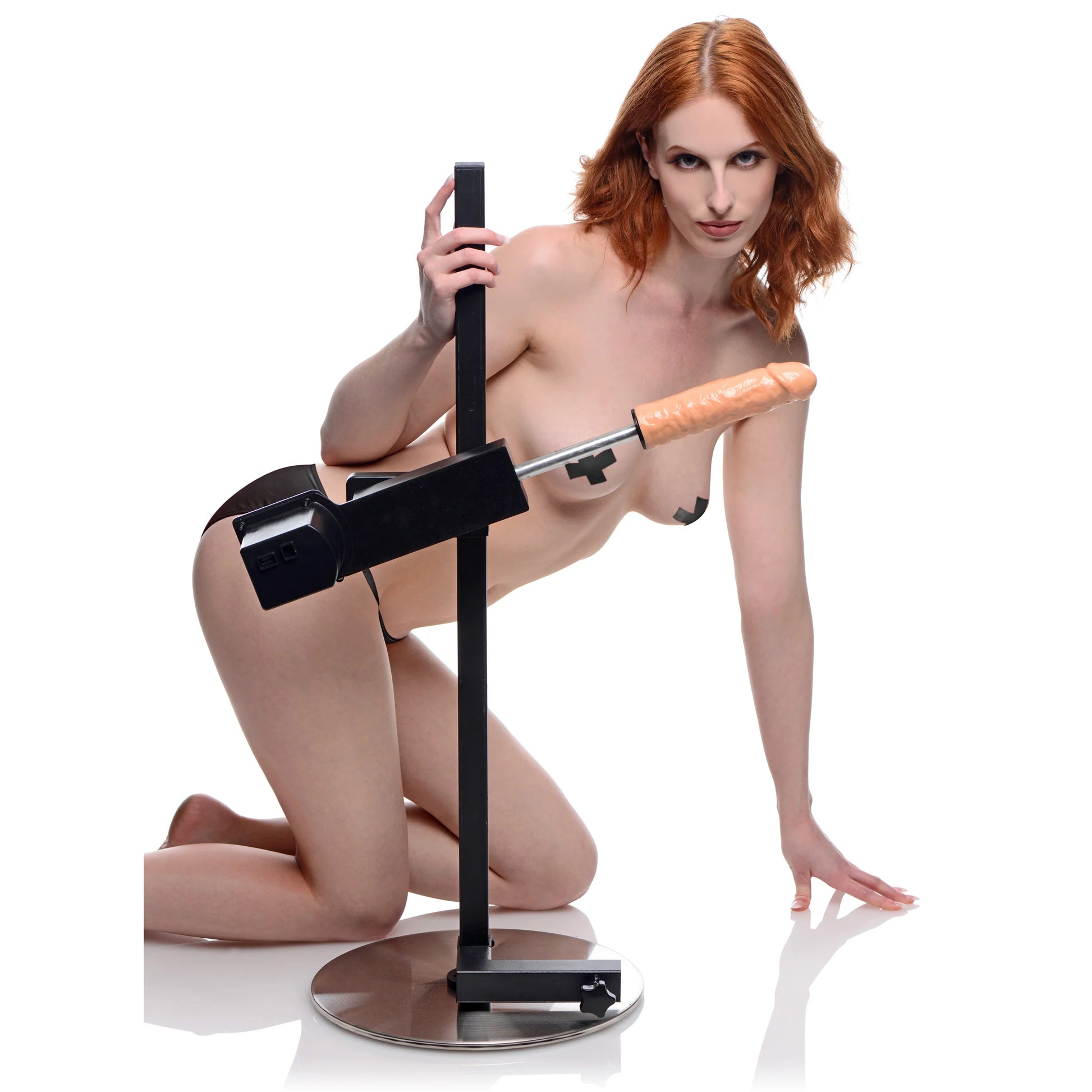 A person is kneeling next to the Dicktator Extreme Sex Machine, showcasing the size of the sex machine. It's much, much taller than your average sex machine, allowing you to use it while on top of the furniture you already own. | Kinkly Shop