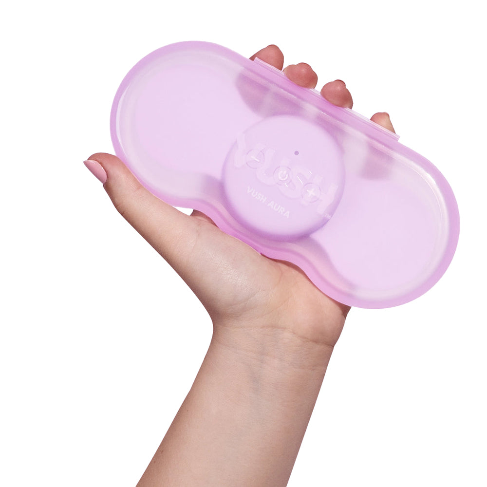 A hand holds the VUSH Aura Wireless TENS Device | Kinkly