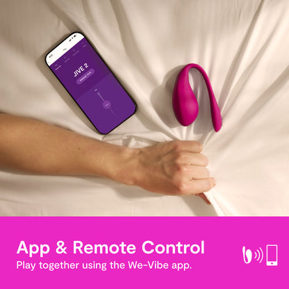 A hand grabs the sheets of the bed tightly as the We-Vibe Jive 2 and cell phone with app are nearby. Text reads: "App & Remote control. Play together using the We-Vibe app." | Kinkly Shop