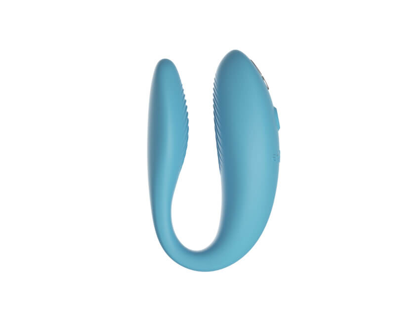 Side profile of the We-Vibe Sync Go. The clitoral end, where the motor is, is much larger in thickness than the insertable end. Both internal sides of each end include ribbing texture to increase pleasurable friction. | Kinkly Shop