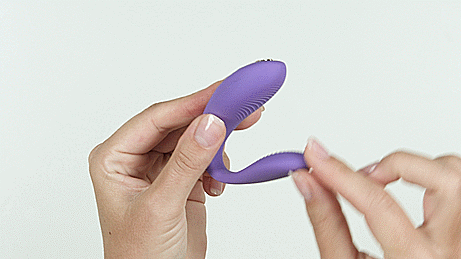 GIF showcases a person's two hands manipulating the We-Vibe Sync Go. They are pulling on the insertable end of the vibrator, showing as the insertable end flexs freely, allowing it to fit a wide variety of anatomies. | Kinkly Shop