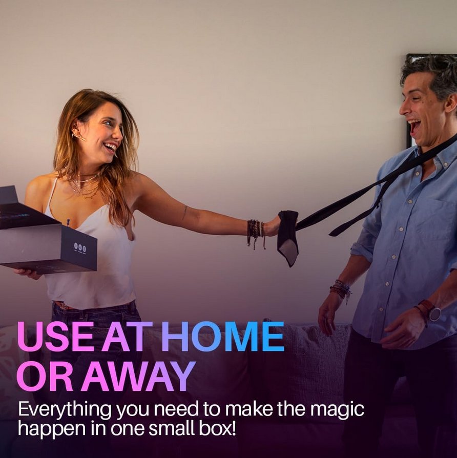 A couple are smiling at one another in what looks like a hotel room. Text on the image reads: "Use at home or away. Everything you need to make the magic happen in one small box!" | Kinkly Shop