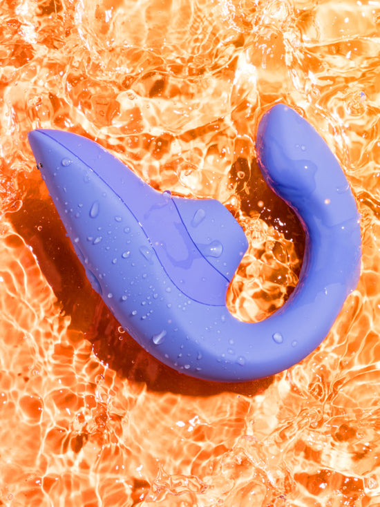 The Womanizer Blend covered in water droplets, showcasing its waterproof capabilities. | Kinkly