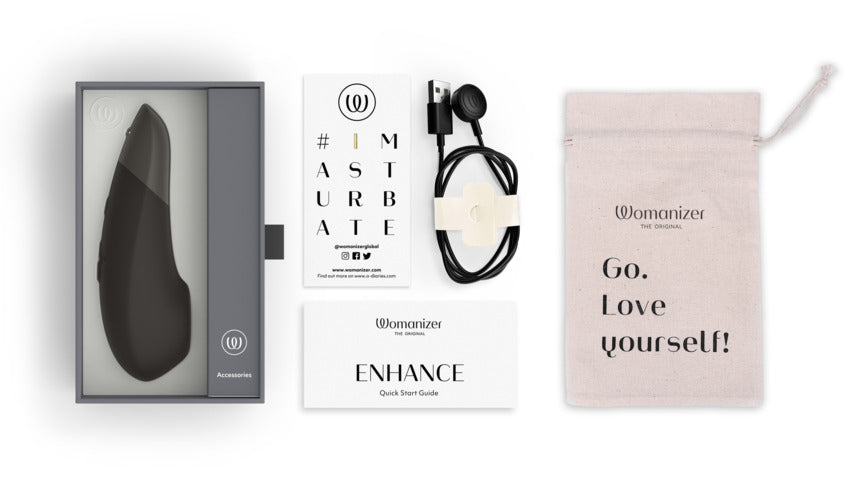 Everything included with the Womanizer Enhance. There's the instruction booklet, charging cable, warranty info, and drawstring storage bag. | Kinkly Shop