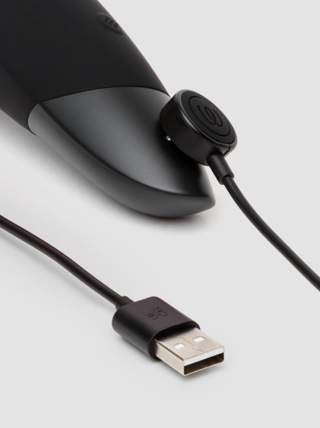 Close up of the magnetic charger attached to the base of the Womanizer Enhance where the charging port connectors are. | Kinkly Shop