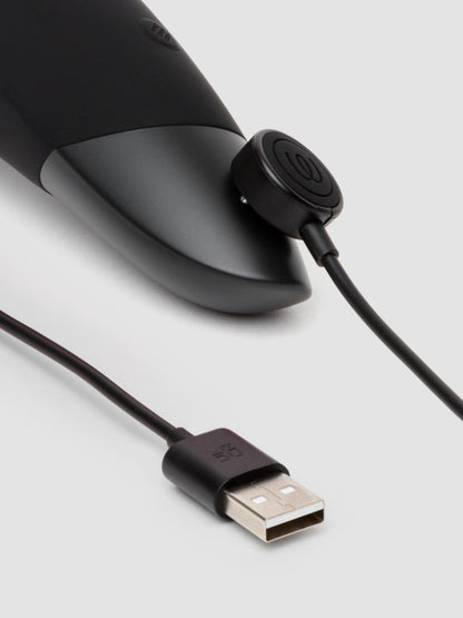 Close up of the magnetic charger attached to the base of the Womanizer Enhance where the charging port connectors are. | Kinkly Shop