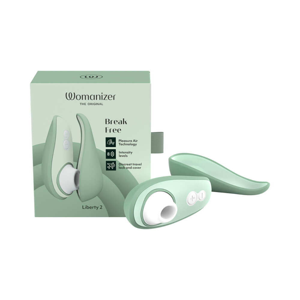 The Womanizer Liberty 2 with its lid laying next to it next to the packaging that it comes in. | Kinkly Shop