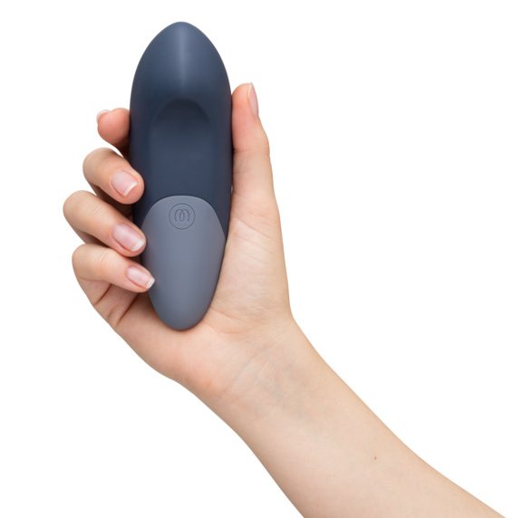 A hand holds the Womanizer Vibe, facing towards the camera. | Kinkly Shop