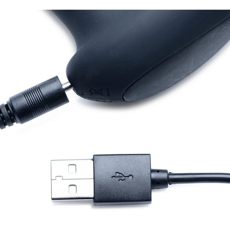 Close-up of the base of the XR Brands Alpha Pro 7x Milker Prostate Stimulator where the charging cable plugs into the base of the p-spot massager. The other end of the charging cable is USB. | Kinkly Shop