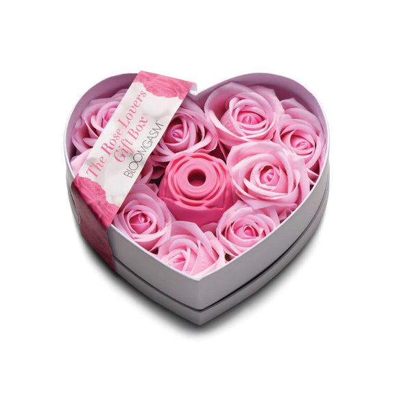 The packaging for the XR Bloomgasm Rose Lover's Gift Box. It's a heart-shaped box. In the middle of the open box, there's the Bloomgasm Rose vibrator. Surrounding this single vibrator is a bunch of faux, color-matched pink roses to make it look like someone is being gifted a full box of roses - only one of them is a vibrator. | Kinkly Shop