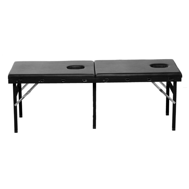 The XR Brands Extreme Bondage Milking Table in front of a plain white background. The XR Brands Extreme Bondage Milking Table has two holes on its surface with foldable legs that are folded out to make up a table. | Kinkly Shop
