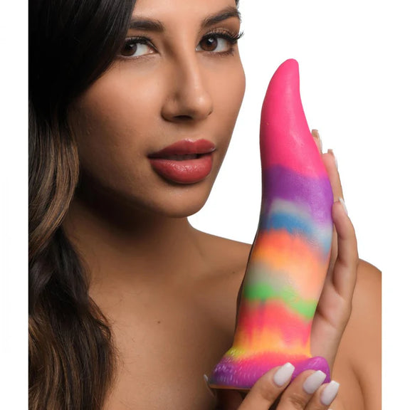 A person holds the Creature Cocks Unicorn Kiss. The dildo is smooth and long, easily longer than the person's face. | Kinkly Shop