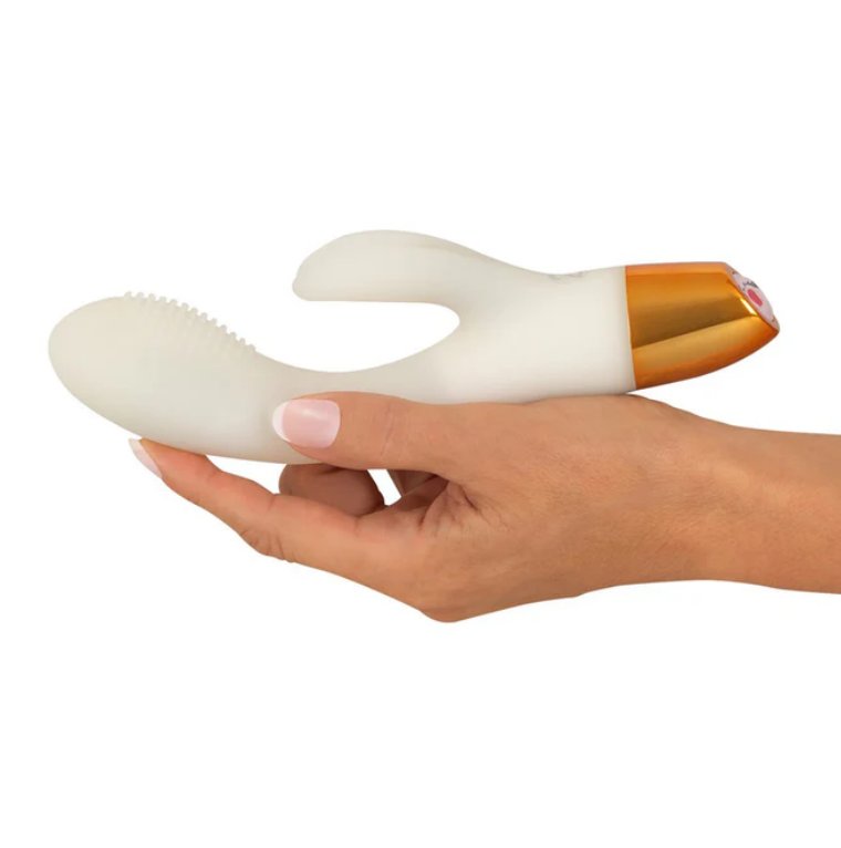 A hand lays flat, holding the You2Toys Glow-in-the-Dark Rabbit. The vibrator is longer than the person's hand by about an inch and a half. | Kinkly Shop