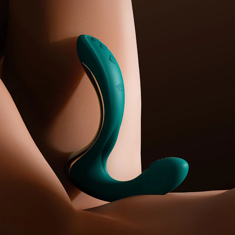 The Zalo Talis in Green leaned up against a brown background. The toy has three buttons on the base of the handle for easy usage. | Kinkly Shop