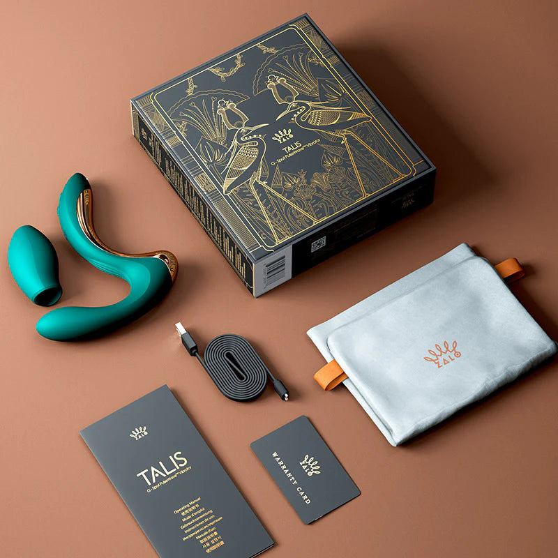 The Zalo Talis shown with everything it comes with including the vibrator, the storage bag, the charging cable, the warranty card, and the instruction manual. | Kinkly Shop